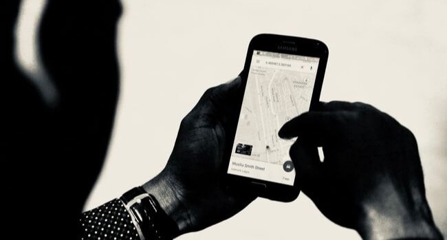 homme avec son téléphone sur application maps